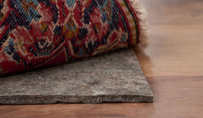 a thick green rug pad under the rug