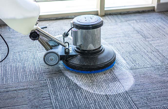 a professional cleaning carpet with shampoo