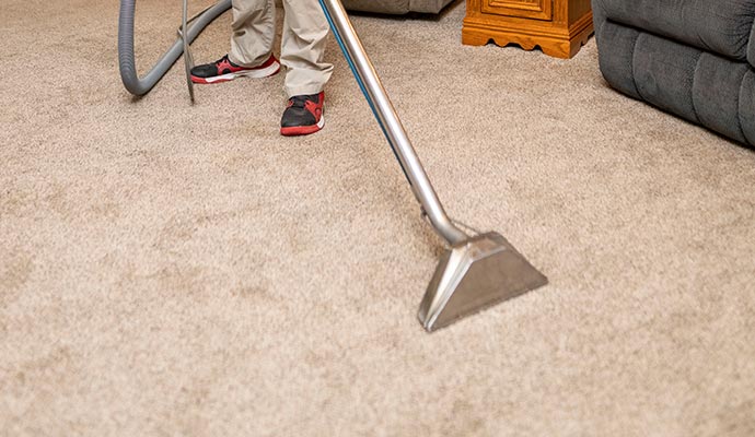 worker dry carpet cleaning