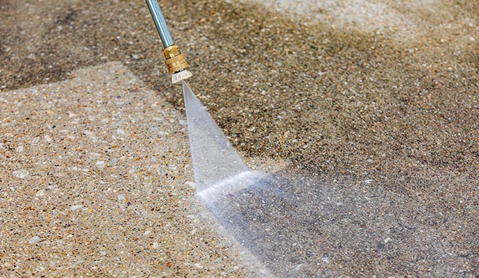 cleaning concrete floor using pressure washing